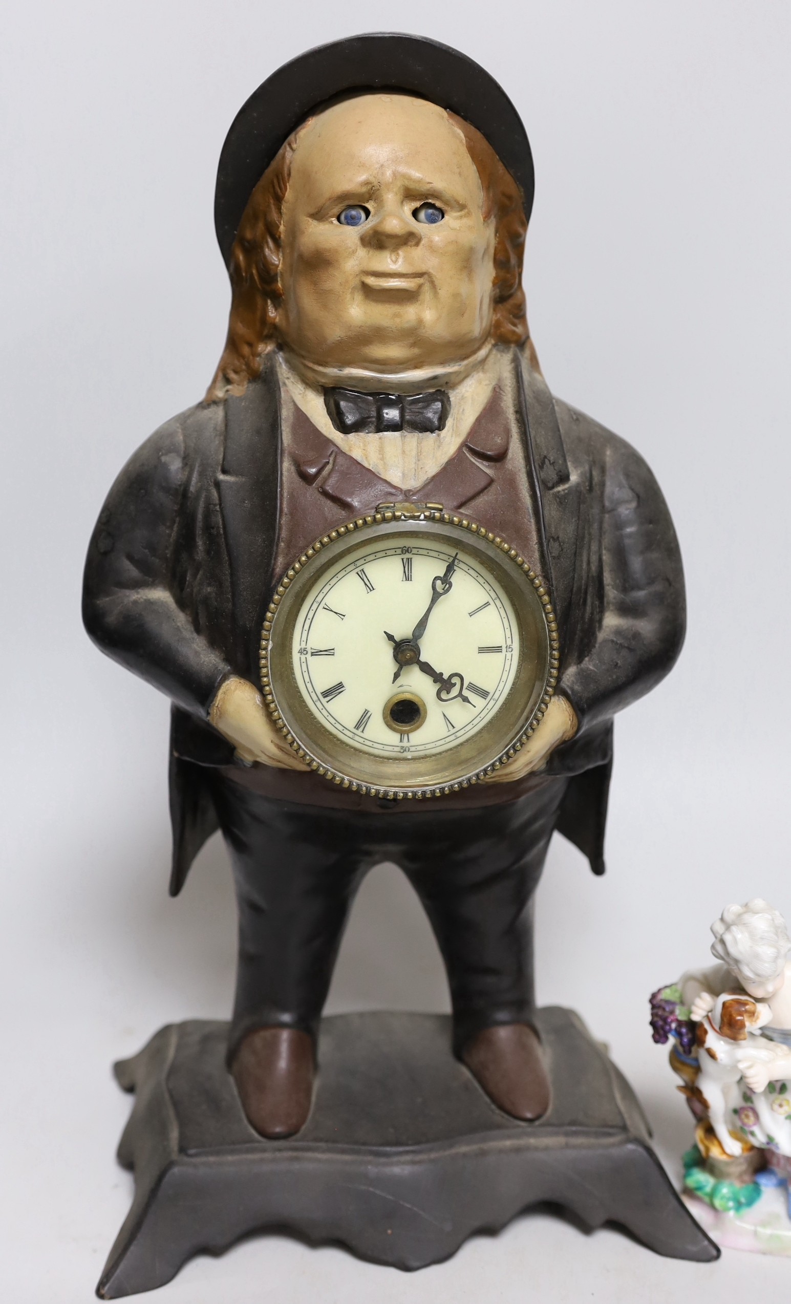 An American cast iron novelty 'John Bull' timepiece and a porcelain group